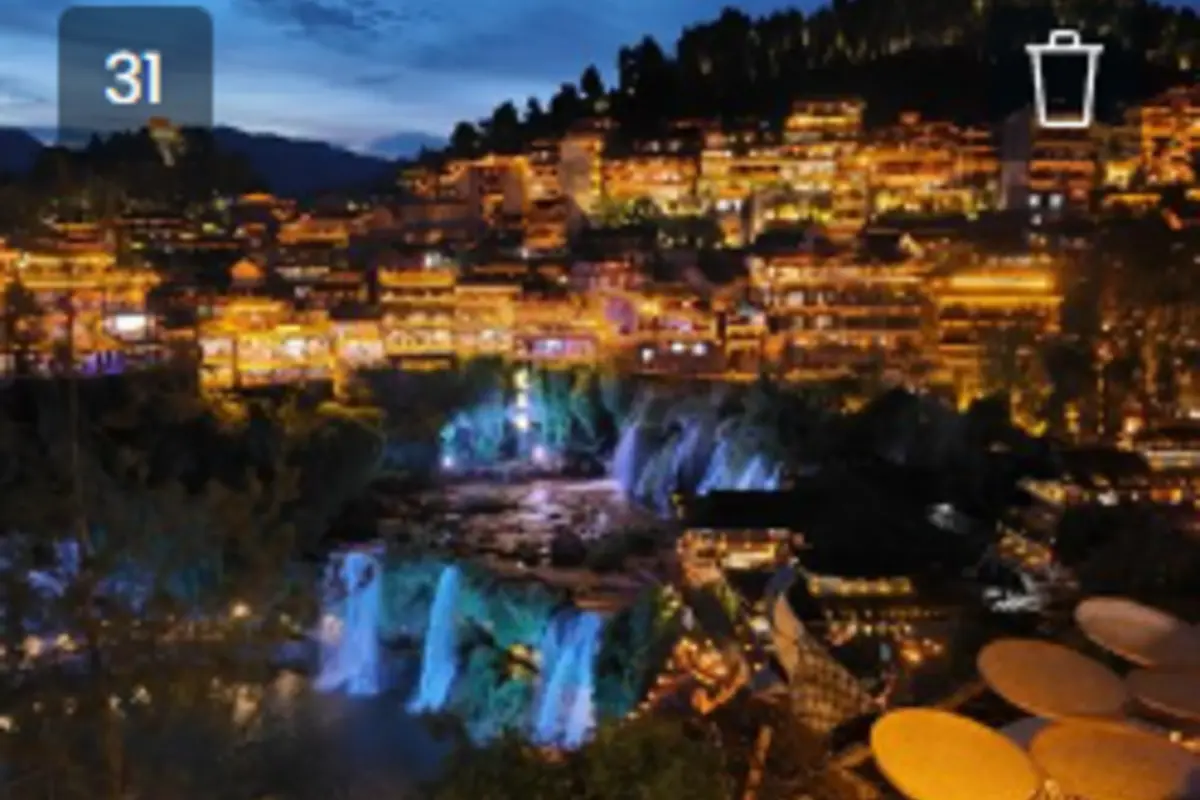 Furong Ancient Town illuminated beside its waterfall